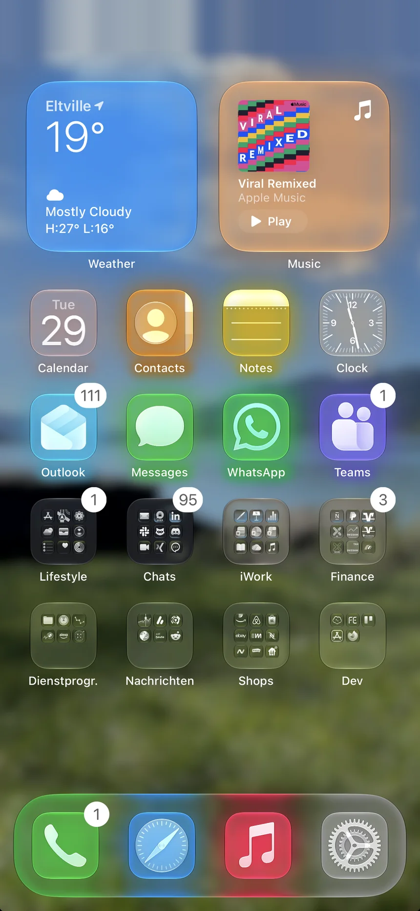 Home Screen with a photo wallpaper and colored glows behind Clear icons